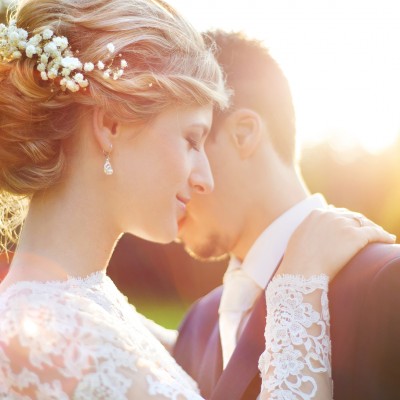 Young wedding couple on summer meadow